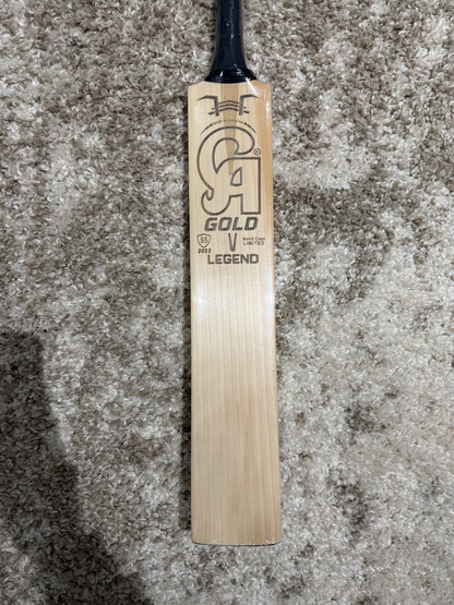 CA Legend english willow - Wooden cricket bat with branding on a textured surface