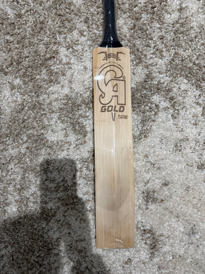 CA Legend english willow - Wooden cricket bat with branding on a textured surface